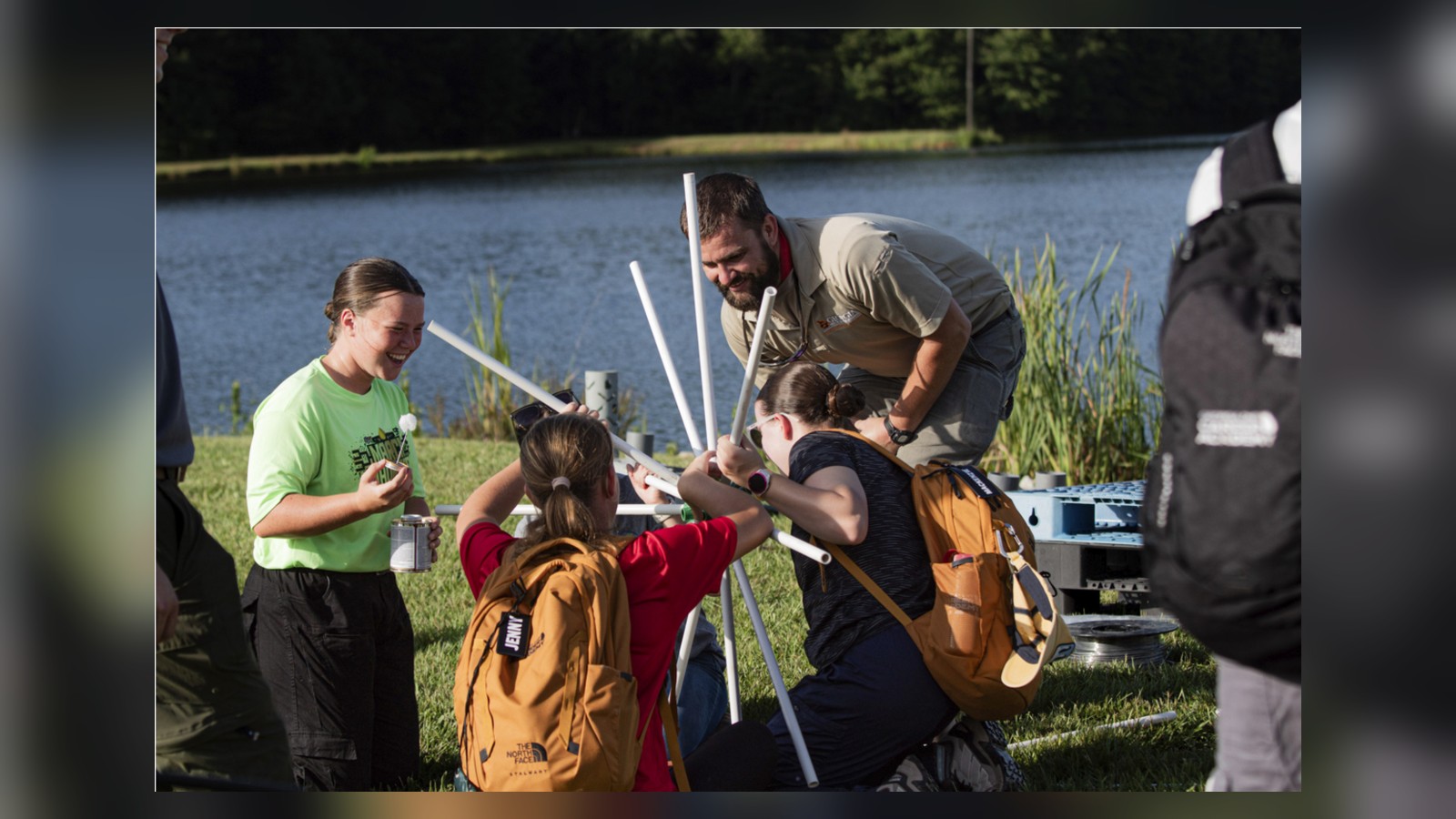 Students participating in a hands-on outdoor activity beside a lake with an instructor, in a photo identified by the article as provided by the Georgia Department of Natural Resources.